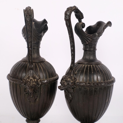 190 - A pair of cast-metal ewers on square bases, H34cm (both urns have no openings at the top)