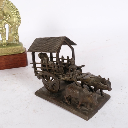 191 - An Indian bronze deity on stand, H16cm, and an Antique bronze oxen and cart on stand (A/F), H8cm (2)