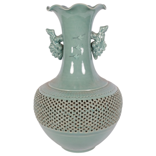 197 - A large Japanese celadon 2-handled vase, having a crane decorated neck, with a pierced and reticulat... 