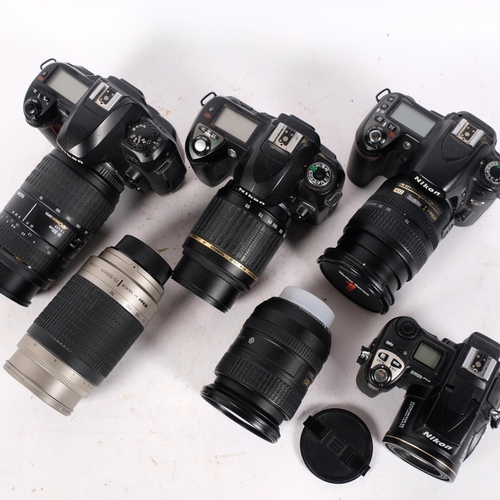 228 - A collection of Nikon digital cameras and lenses, including a D100 with a Sigma 70-300mm 1:4-5.6D ma... 