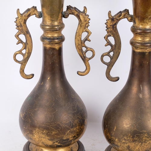 231 - A pair of Chinese gilt-metal table lamps on turned wood stands, with dragon handles and engraved dec... 