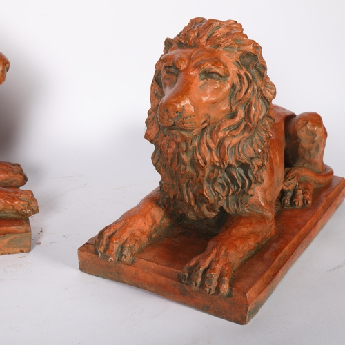 302 - An impressive pair of terracotta recumbent lion figures, base 38cm x 20cm