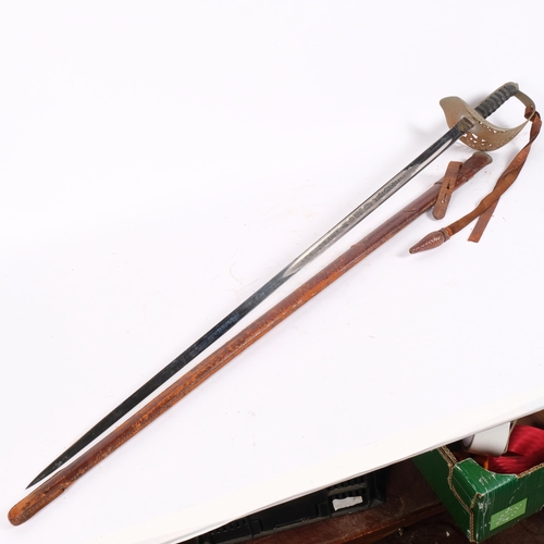 31 - A 1897 pattern Infantry Officer's sword with leather scabbard, having an engraved blade marked GR, a... 