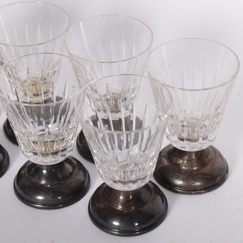 329 - A set of 8 sterling silver-mounted glass shot glasses, 7cm