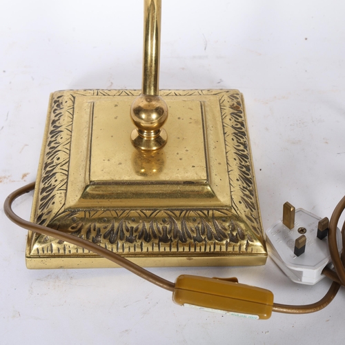 341 - A brass desk lamp with amber glass swivel shade