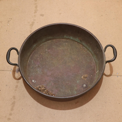 357 - A Victorian 2-handled copper pan, 59cm across overall