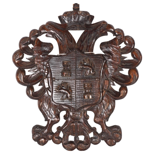 414 - An Antique wall-hanging letter holder, carved with emblems of lions and castles, H50cm