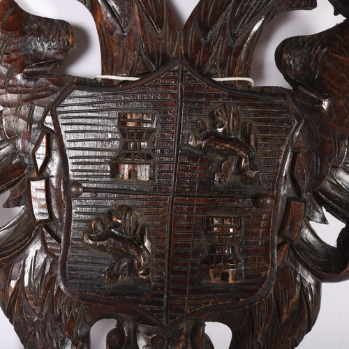 414 - An Antique wall-hanging letter holder, carved with emblems of lions and castles, H50cm