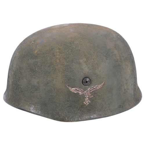 44 - A reproduction German World War II Paratrooper's helmet, with leather strap