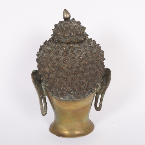 444 - A Tibetan bronze Buddha head, 30cm