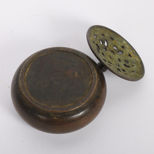 446 - A Chinese patinated bronze incense burner and cover, 9cm