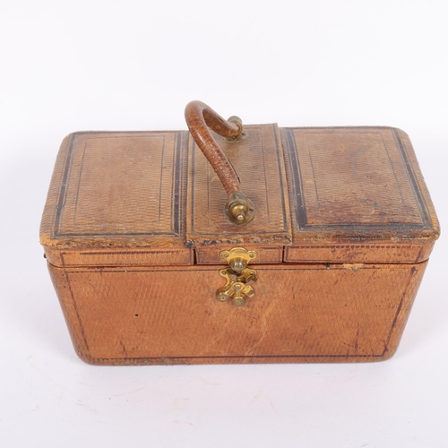 454 - An Antique Victorian leather travelling sewing box, with triple-hinged cover opening to reveal fitte... 