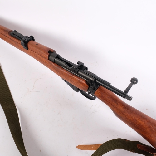 55 - A Denix replica copy of a no. 1 Lee Enfield 303 rifle, with shoulder strap and a magazine, L112cm