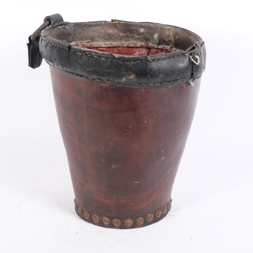 65 - A 19th century studded leather fire bucket (lacking handle), height 27cm