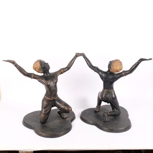 8 - A pair of hollow cast and patinated bronze African kneeling dancing figures, on trefoil bases, H41cm