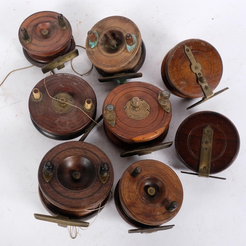 80 - A collection of Vintage wooden and brass-mounted fishing reels, widest 4