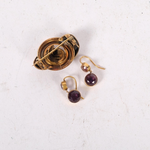 609 - A pair of 15ct gold and amethyst set pendant earrings, 2.9g, and an unmarked gold knot design brooch... 