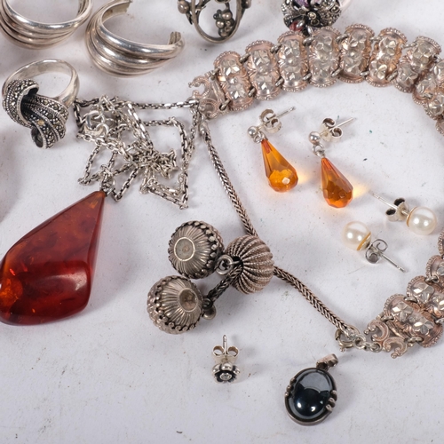 630 - A group of silver jewellery, including 4 rings, including amber set, an amber pendant, etc