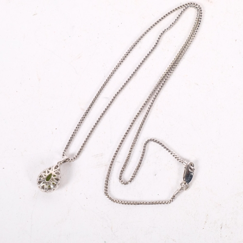 635 - A delicate 9ct white gold teardrop pendant and chain, set with a peridot and diamond surround, on an... 