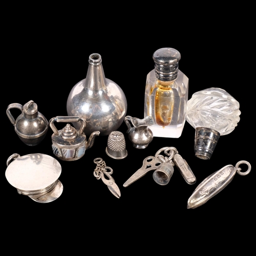 638 - A group of miniature silver charms, scent bottle, etc, charms in the form of a agate set kettle, thi... 