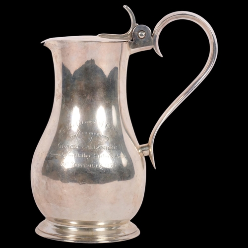 648 - A George V silver hot water jug, with presentation inscription reading To The Glory Of God - and in ... 