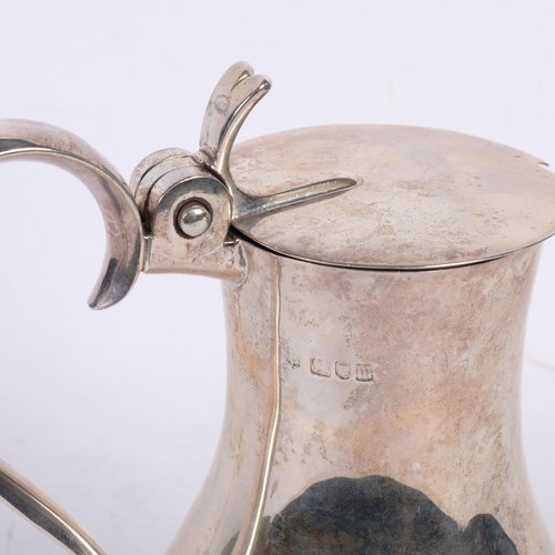 648 - A George V silver hot water jug, with presentation inscription reading To The Glory Of God - and in ... 