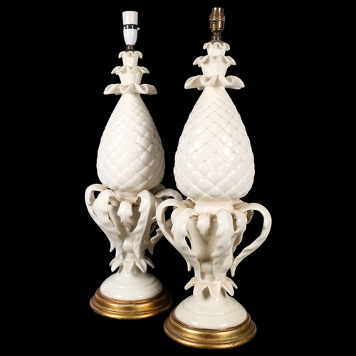 649 - CASA PUPO - A pair of Continental ceramic pineapple design table lamps, on giltwood plinths, height ... 