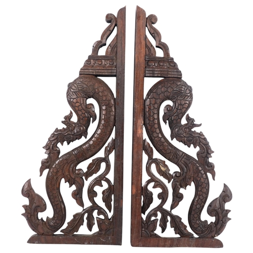 672 - A pair of Eastern carved hardwood brackets, in the form of mythological beasts, H52cm