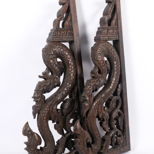 672 - A pair of Eastern carved hardwood brackets, in the form of mythological beasts, H52cm