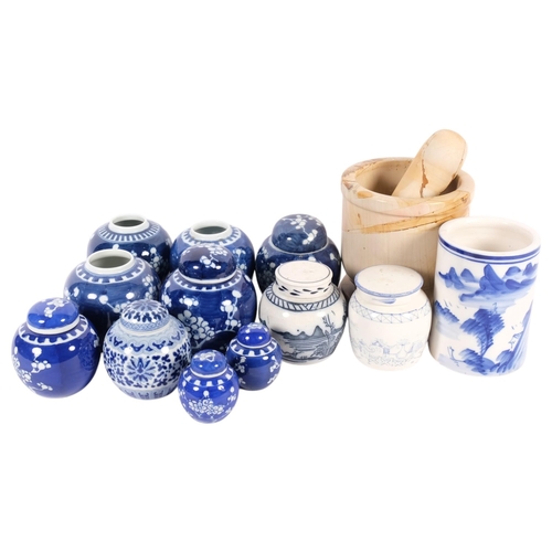 713 - A pestle and mortar, blue and white ginger jars, some with covers, and a blue and white cylindrical ... 