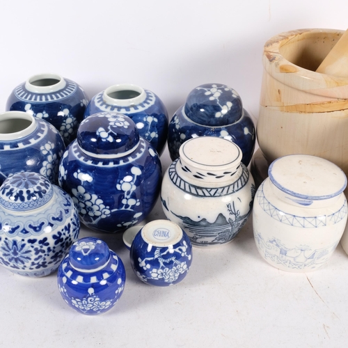 713 - A pestle and mortar, blue and white ginger jars, some with covers, and a blue and white cylindrical ... 