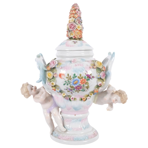 722 - A porcelain pot pourri jar and cover in Meissen style, with cherub figures, 29.5cm