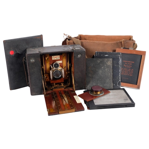 730 - An Edwardian Sanderson mahogany and brass roll film camera, with plates, 21.5cm across