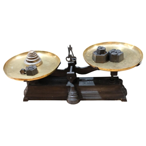 891 - A pair of French cast-iron brass pan balance scales, with metric and imperial weights, length overal... 