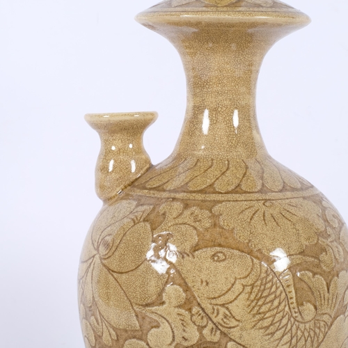 903 - A Chinese incised and glazed jug, with design of fish, H34cm