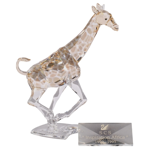 947 - SWAROVSKI - a model of a tinted running giraffe, H17cm, boxed, together with a Swarovski Inspiration... 