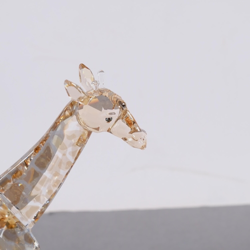 947 - SWAROVSKI - a model of a tinted running giraffe, H17cm, boxed, together with a Swarovski Inspiration... 