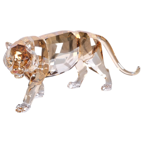 948 - SWAROVSKI - a tinted model of a prowling tiger, L19cm, boxed with certificate of authenticity