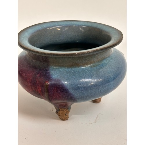 902 - A Chinese stoneware glazed pot on 3 feet, 15cm across