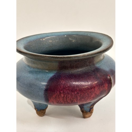 902 - A Chinese stoneware glazed pot on 3 feet, 15cm across