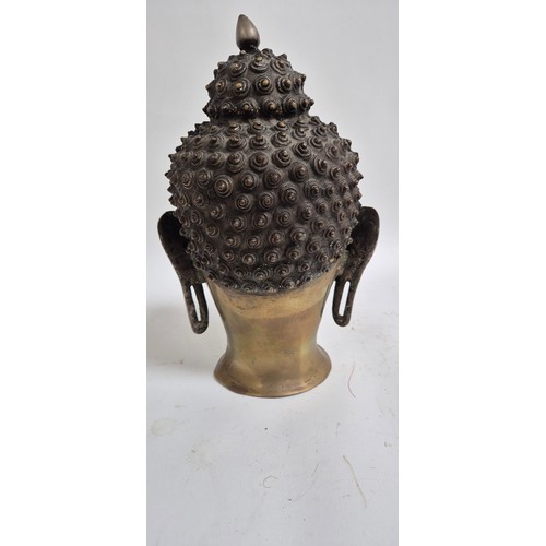 444 - A Tibetan bronze Buddha head, 30cm