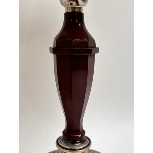 18 - A 1930s Art Deco table lamp in Bakelite, having a sterling silver base with martele finish, marked f... 