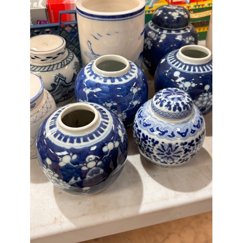 713 - A pestle and mortar, blue and white ginger jars, some with covers, and a blue and white cylindrical ... 