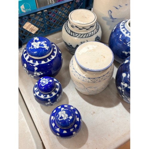 713 - A pestle and mortar, blue and white ginger jars, some with covers, and a blue and white cylindrical ... 