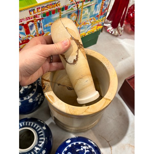 713 - A pestle and mortar, blue and white ginger jars, some with covers, and a blue and white cylindrical ... 