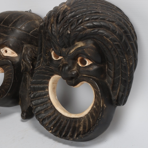 197 - A pair of mid-20th century plaster wall masks, longest 27cm, and another Indian style papier-mache d... 