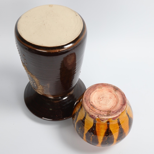 20 - A large studio pottery candle holder, Tenmoku glaze, maker's mark at base, together with a slipware ... 