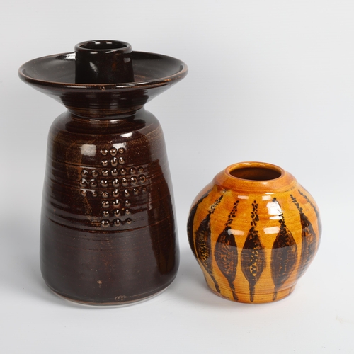 20 - A large studio pottery candle holder, Tenmoku glaze, maker's mark at base, together with a slipware ... 