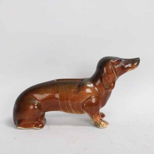 235 - A ceramic Austrian figurine of a Daschund as a money box, shaded brown glaze, base stamped Austria, ... 