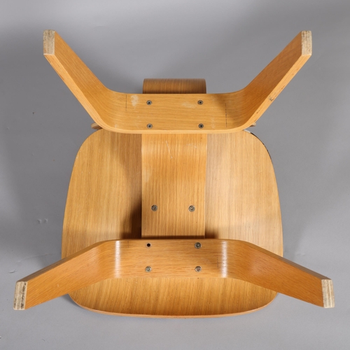 31 - An Eames LCW style chair with oak veneer bent ply and cowhide seat, no maker's mark, height 74cm